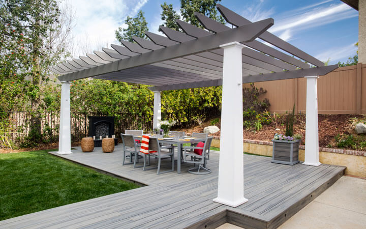 This is an image of a Trex Pergola with a grey colored lattice and white posts.