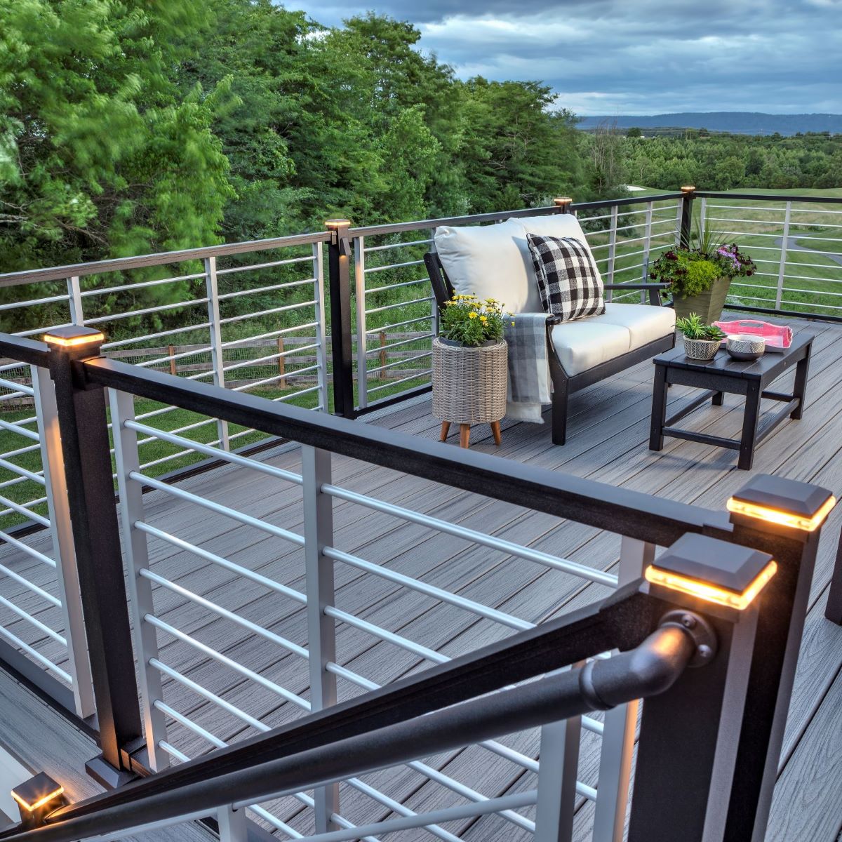 This is a picture of Trex Signature railing in black with light post caps on and horizontal metal balusters.