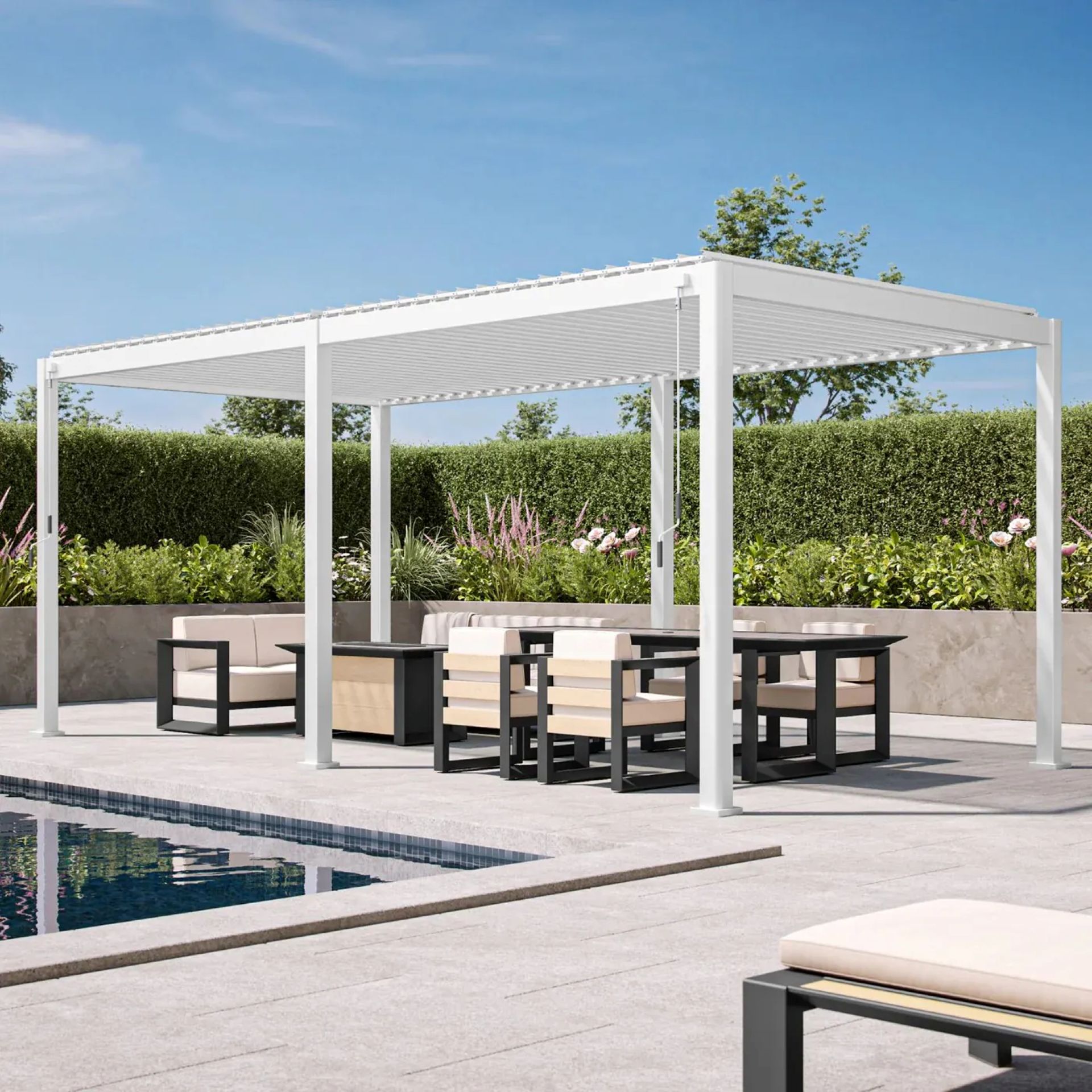 White freestanding aluminum pergola with a louvered roof over a poolside patio and outdoor seating.