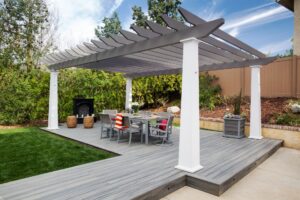 Gray and white open-roof pergola over a composite deck with an outdoor dining area.