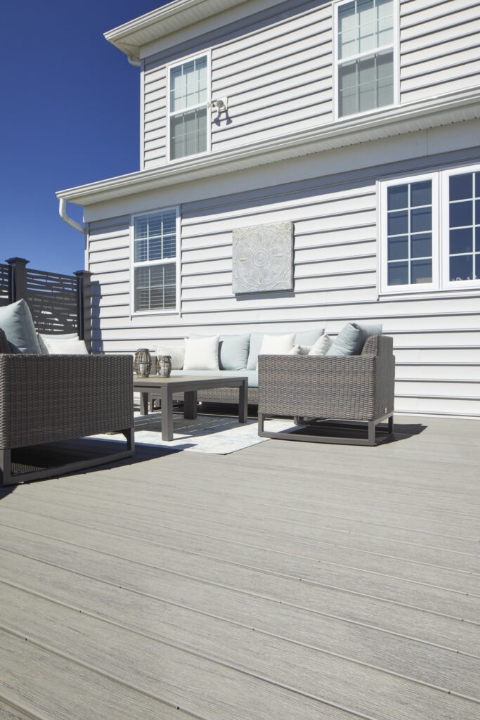 Outdoor seating area on TimberTech Reserve Collection - Driftwood composite decking, featuring a weathered gray finish with deep color variations.