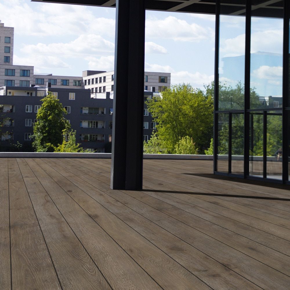 Eva-Last Pioneer decking in Natural Ipe surrounds a modern backyard pool, showcasing its rich brown color and soft grain detail in a clean, spacious layout.