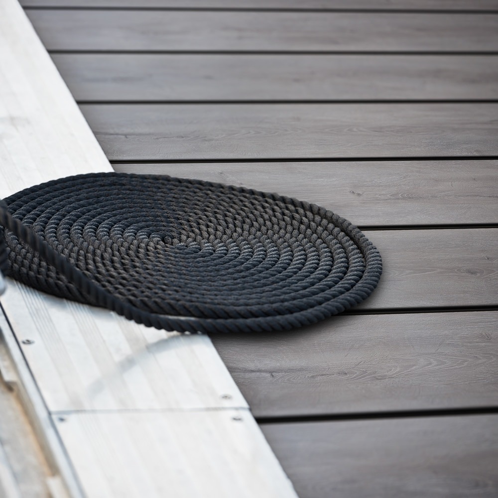 Close-up of Eva-Last Pioneer Weathered Ash decking with subtle grain detail, next to nautical rope and dock edging.