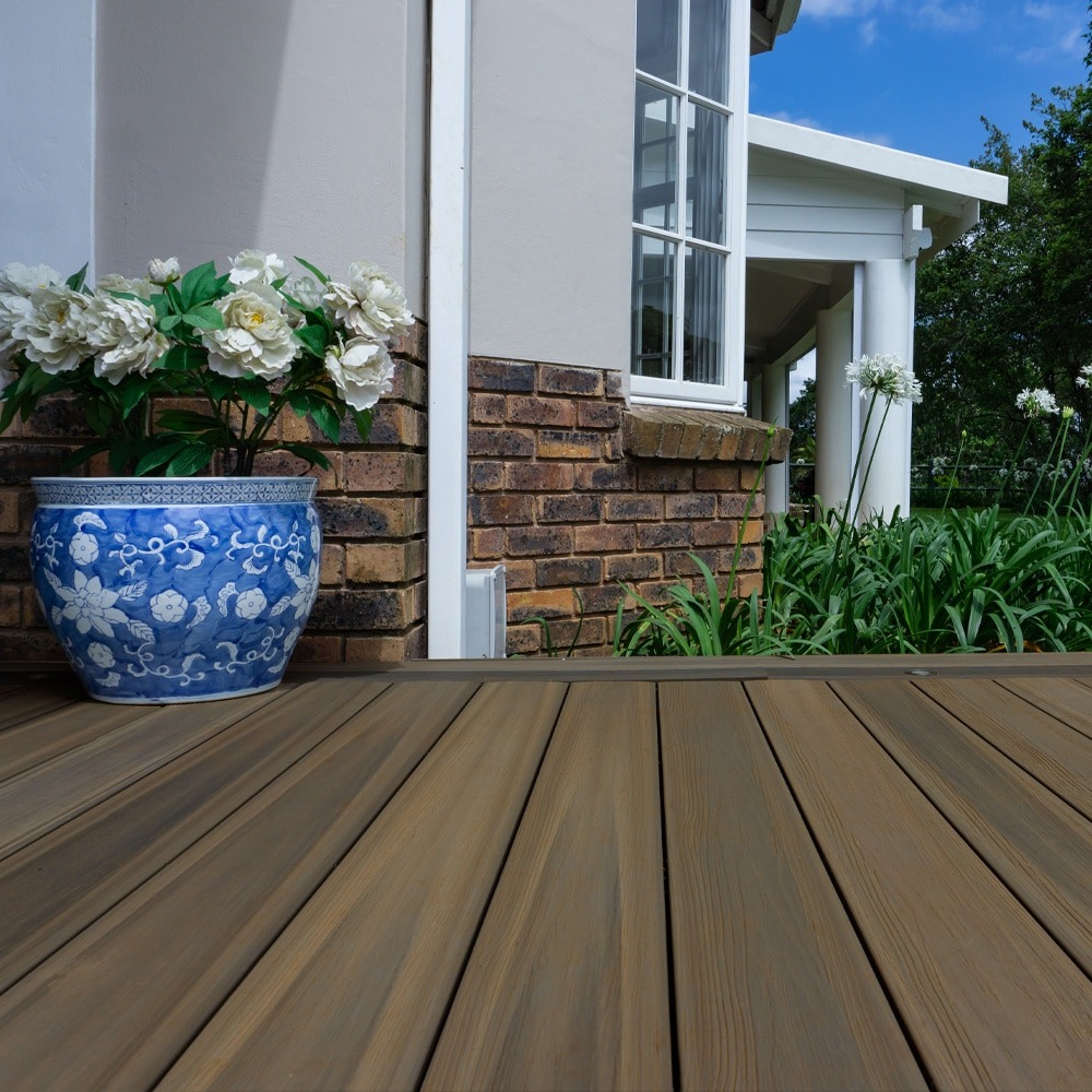 Oasis Palm decking installed in a cozy backyard patio, showcasing natural wood tones and a relaxed outdoor living space.