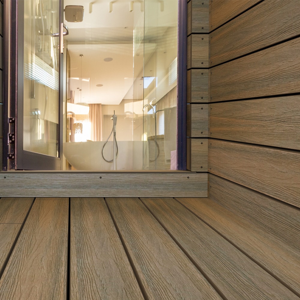 Close-up view of Oasis Palm deck boards installed vertically and horizontally, enhancing a luxurious bathroom entryway.