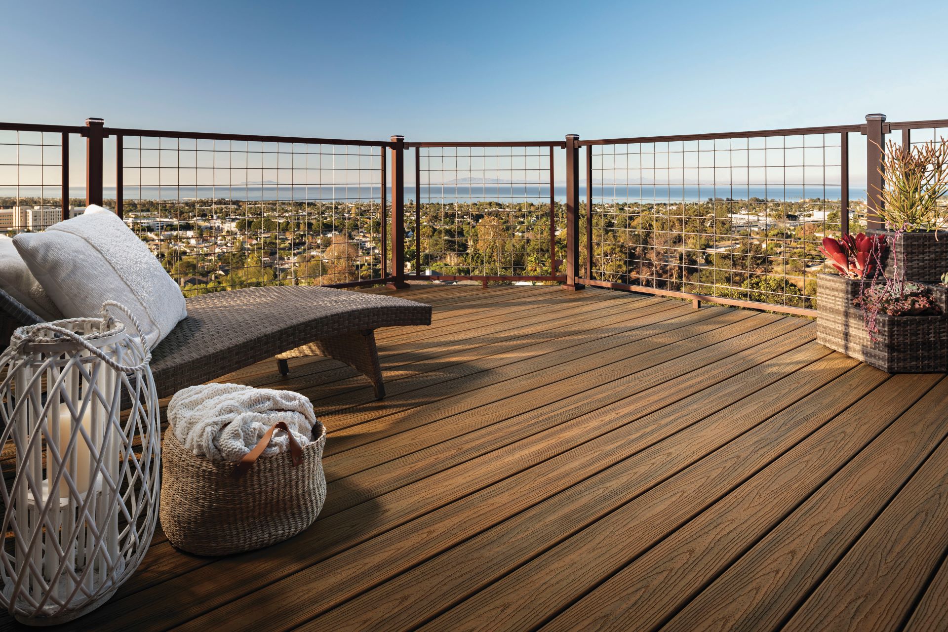 Modern wire mesh deck railing overlooking a city view, installed at compliant railing height for residential or commercial decks.
