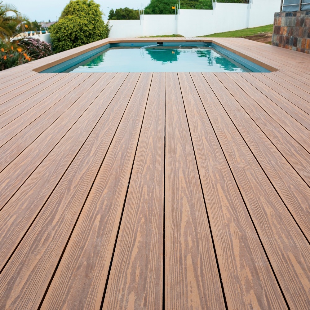 Eva-Last Eva-Tech IS decking in Savanna dual tone installed around a modern backyard pool area, creating a warm, natural look.