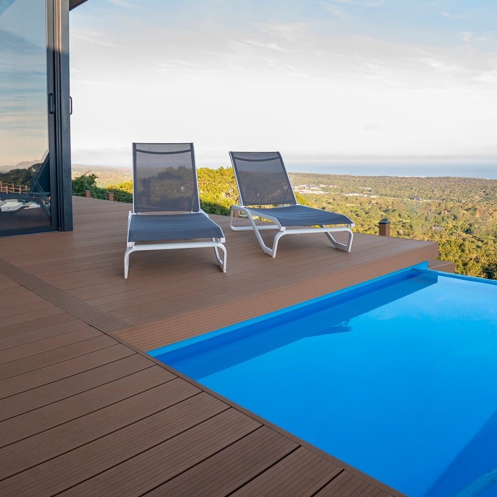 Rusteak Wyde decking from Eva-Tech IS framing a pool with a panoramic view, designed for comfort and elegance.