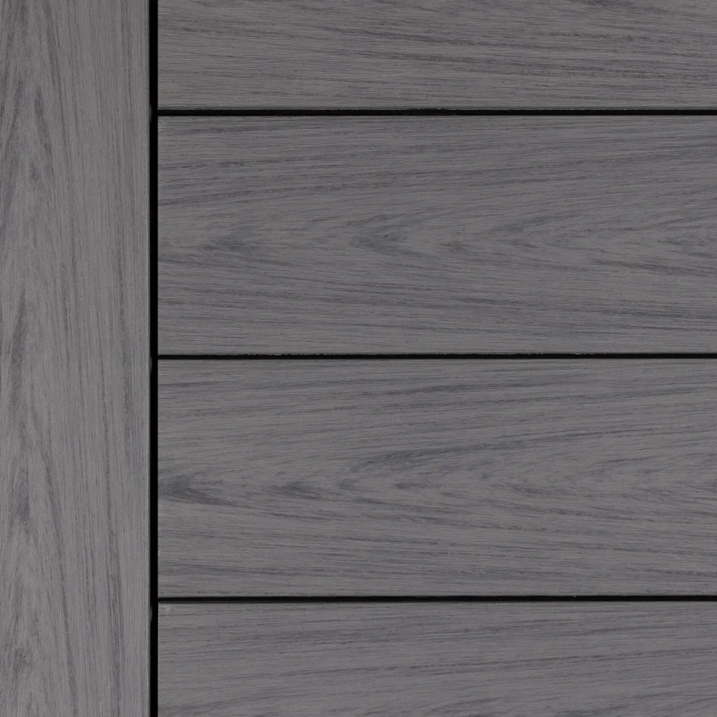 Close-up swatch of Deckorators Vault decking in Dusk, featuring a cool-toned gray base with subtle wood grain texture and natural-looking striations.