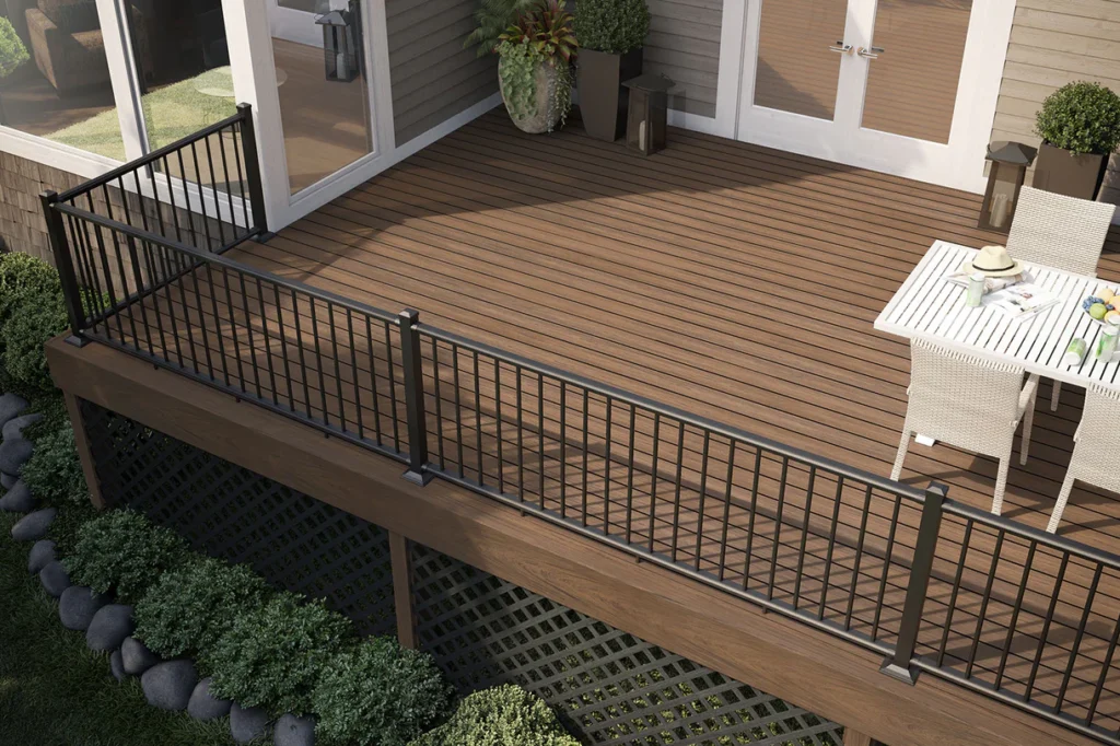Elevated backyard deck featuring Deckorators Vault Mesquite decking with sleek black metal railings and cozy white patio furniture.