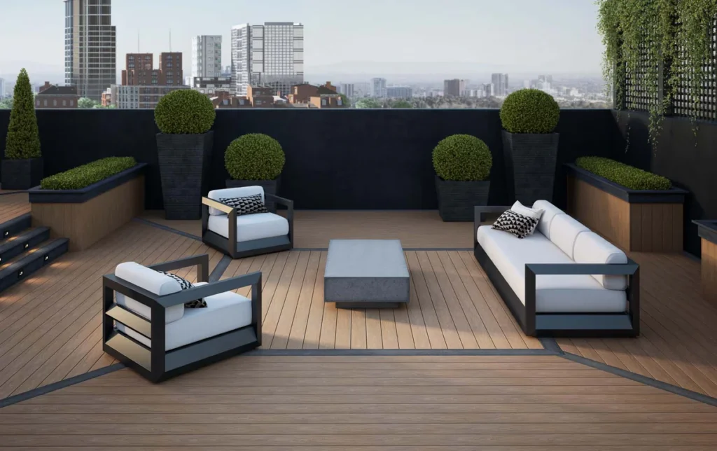 Modern rooftop lounge showcasing Deckorators Vault Mesquite deck boards with dark border inlay and minimalist outdoor seating overlooking the city skyline.