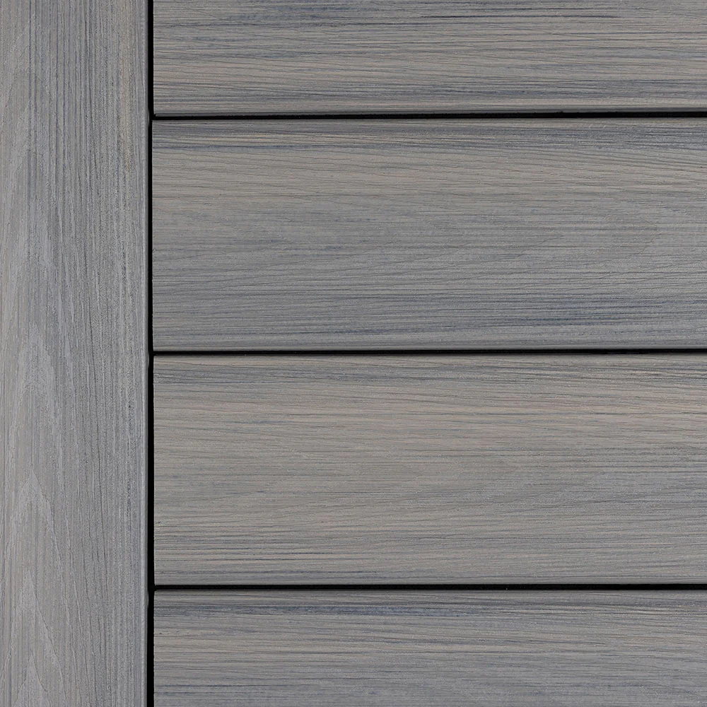 Close-up view of Deckorators Vista decking in Driftwood - a deep gray composite board with subtle wood grain texture for a weathered, coastal-inspired look.