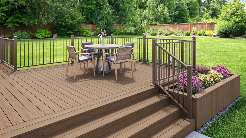 A backyard deck built with Deckorators Venture Sandbar decking, showcasing a rich brown hue and clean-lined surface surrounded by garden planters and outdoor seating - perfect for relaxed, low-maintenance living.