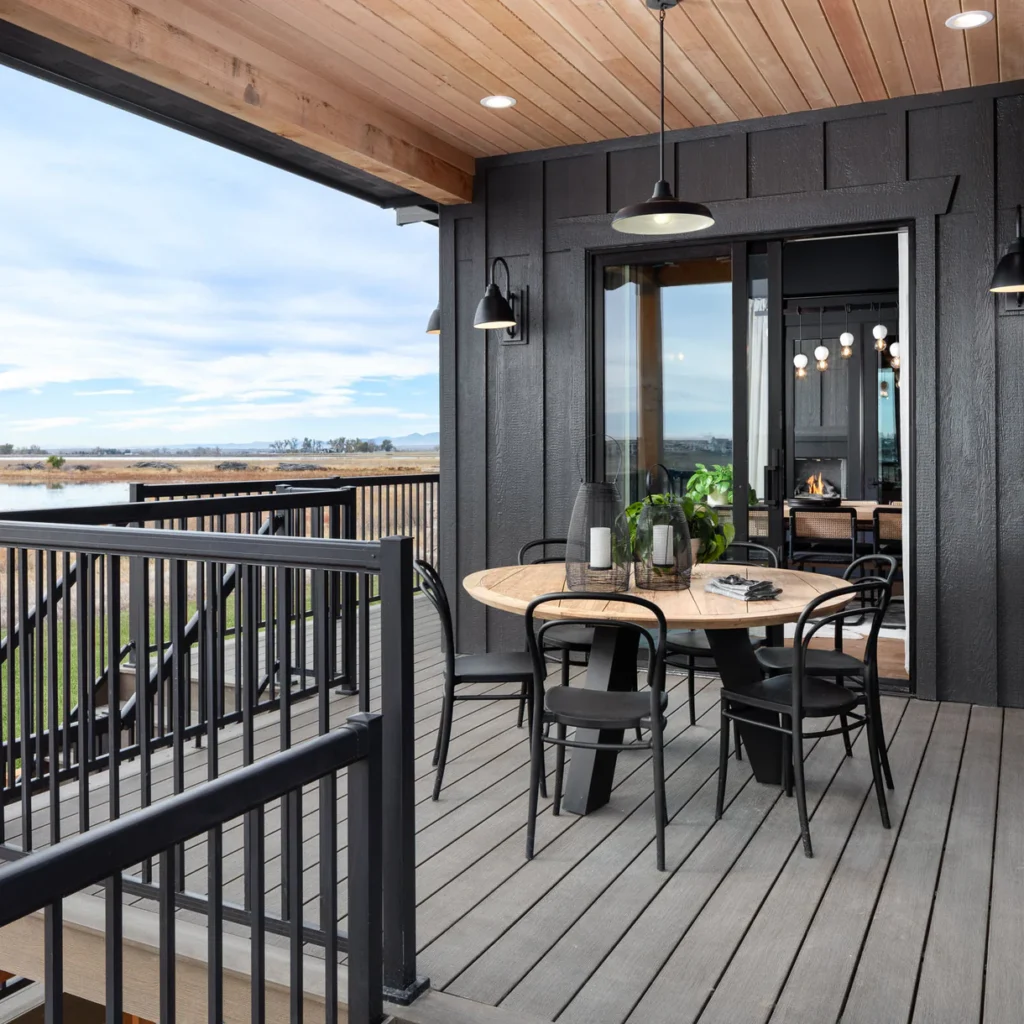 Modern backyard deck built with Deckorators Vista Driftwood composite decking, featuring warm grey and brown tones in natural sunlight.