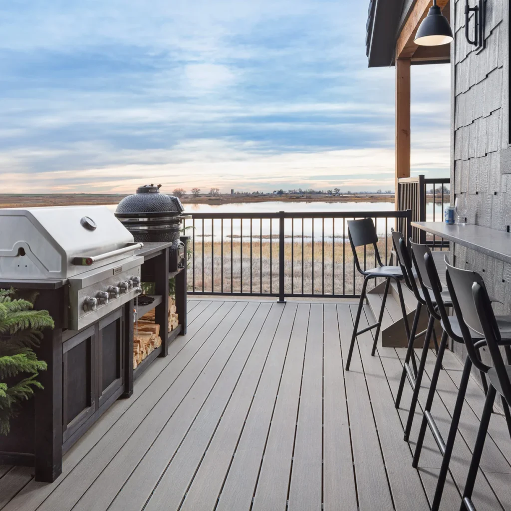 Close-up view of a Driftwood deck board installation, showcasing the realistic woodgrain texture and multi-tonal color variation.