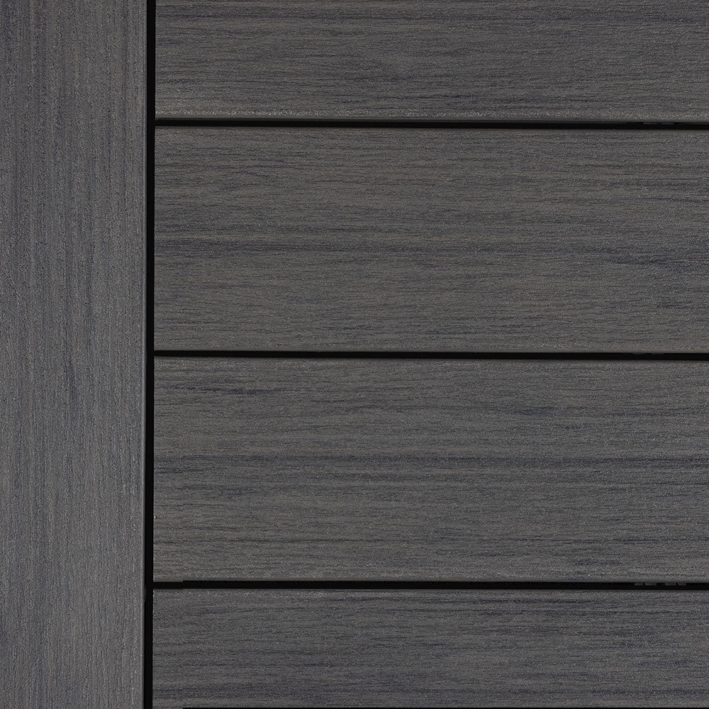 Close-up view of Deckorators Vista decking in Driftwood - a deep gray composite board with subtle wood grain texture for a weathered, coastal-inspired look.