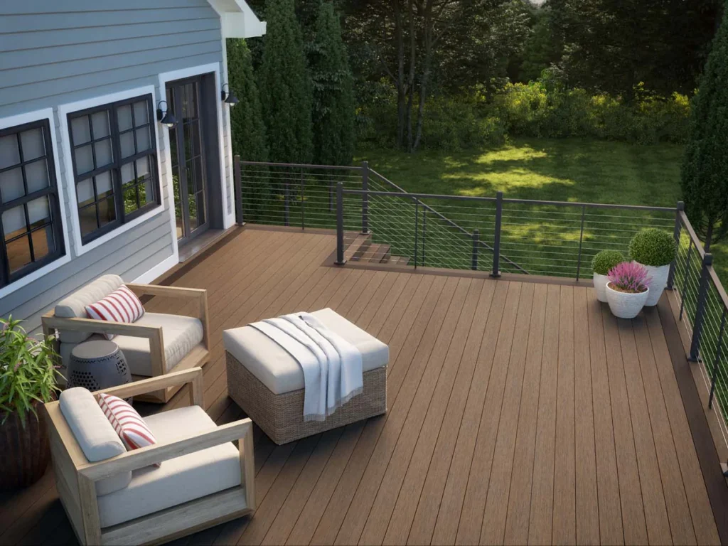 Modern backyard deck built with Deckorators Vista Driftwood composite decking, featuring warm grey and brown tones in natural sunlight.