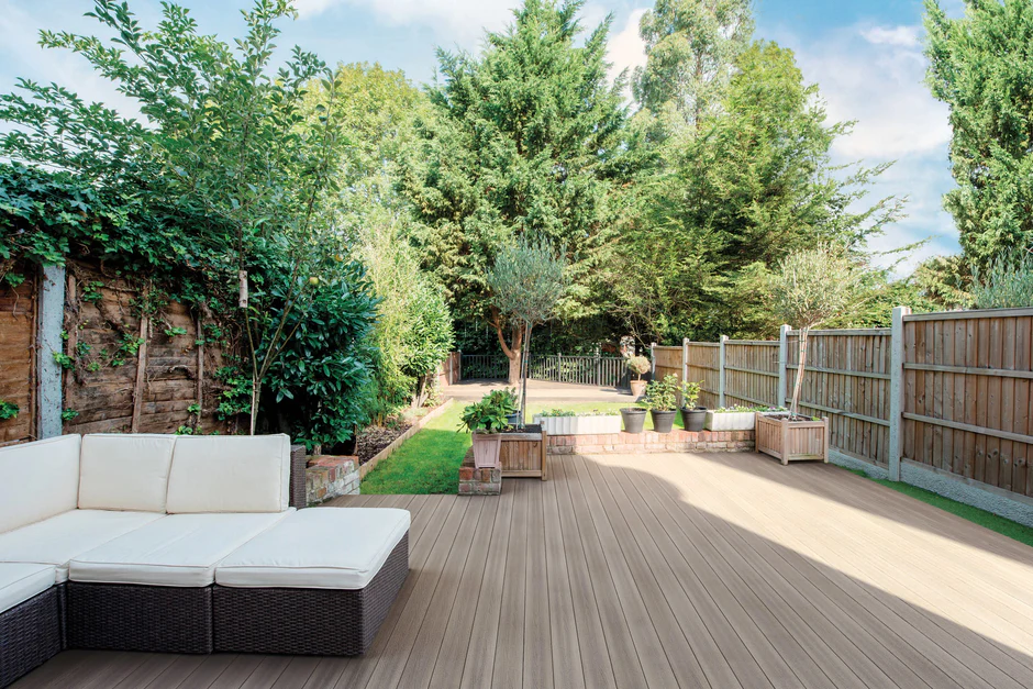 Bright, sunlit deck using Good Life Cabana boards, with a light wood tone that complements soft white patio furniture and natural landscaping for a beachy aesthetic.