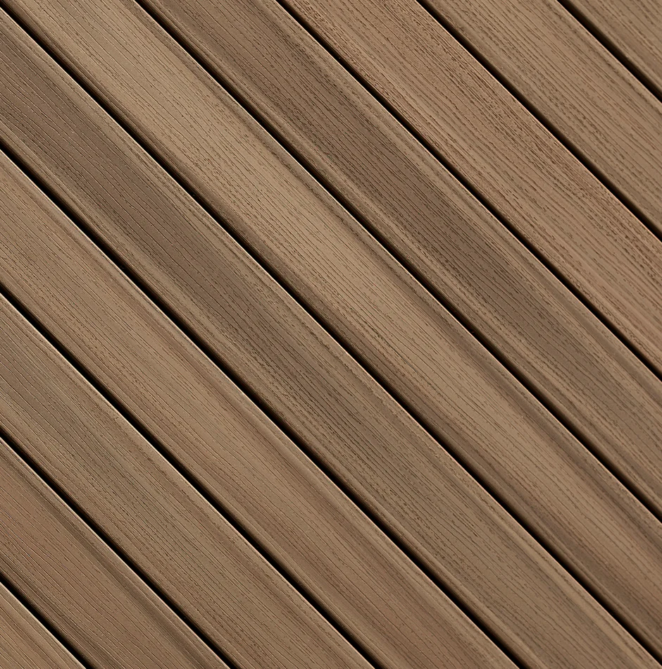 Close-up view of Fiberon Paramount decking in Brownstone, featuring warm mid-tone brown planks with natural woodgrain texture and low-gloss finish.