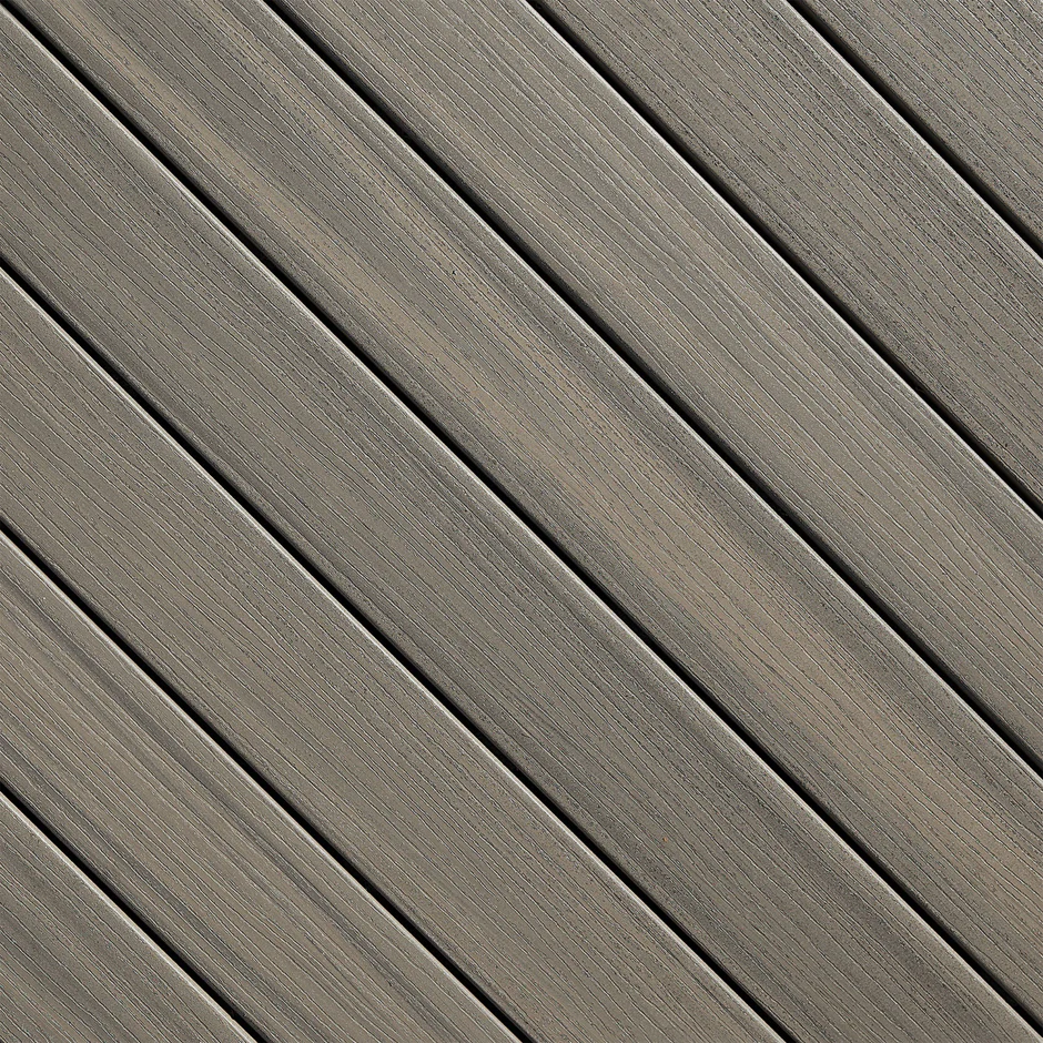 Close-up of Fiberon Promenade decking in Sandy Pier, a golden brown tone with understated streaks. Evokes the look of sunlit wood for bright, natural spaces.