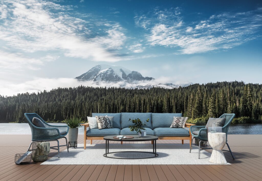 Lakeside deck showcasing Fiberon Promenade in Natural Reef, paired with blue outdoor seating and mountain views, creating a rich, warm foundation for scenic relaxation.