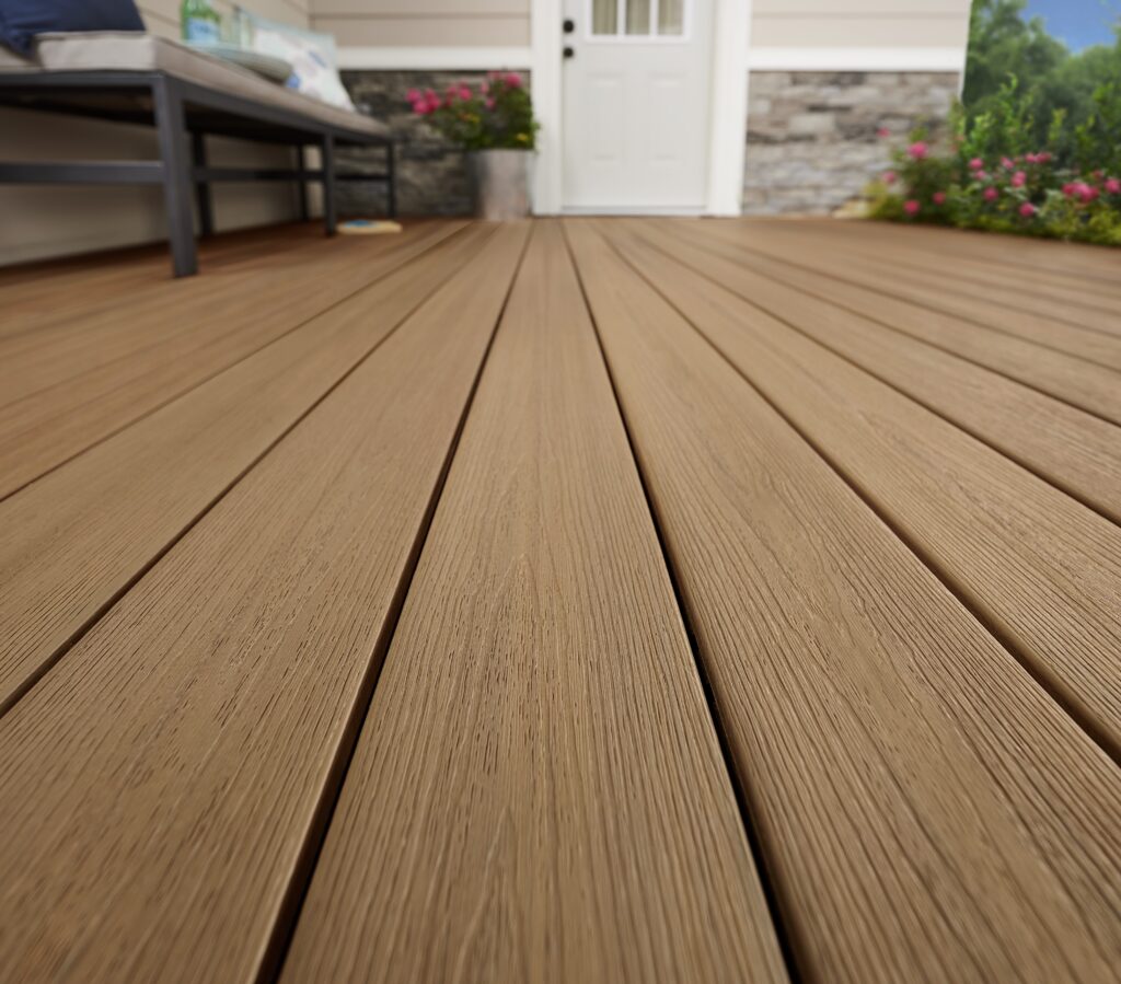 Ground-level backyard retreat with Fiberon Sanctuary Moringa decking, surrounded by lush landscaping and modern patio furniture in earthy, complementary tones