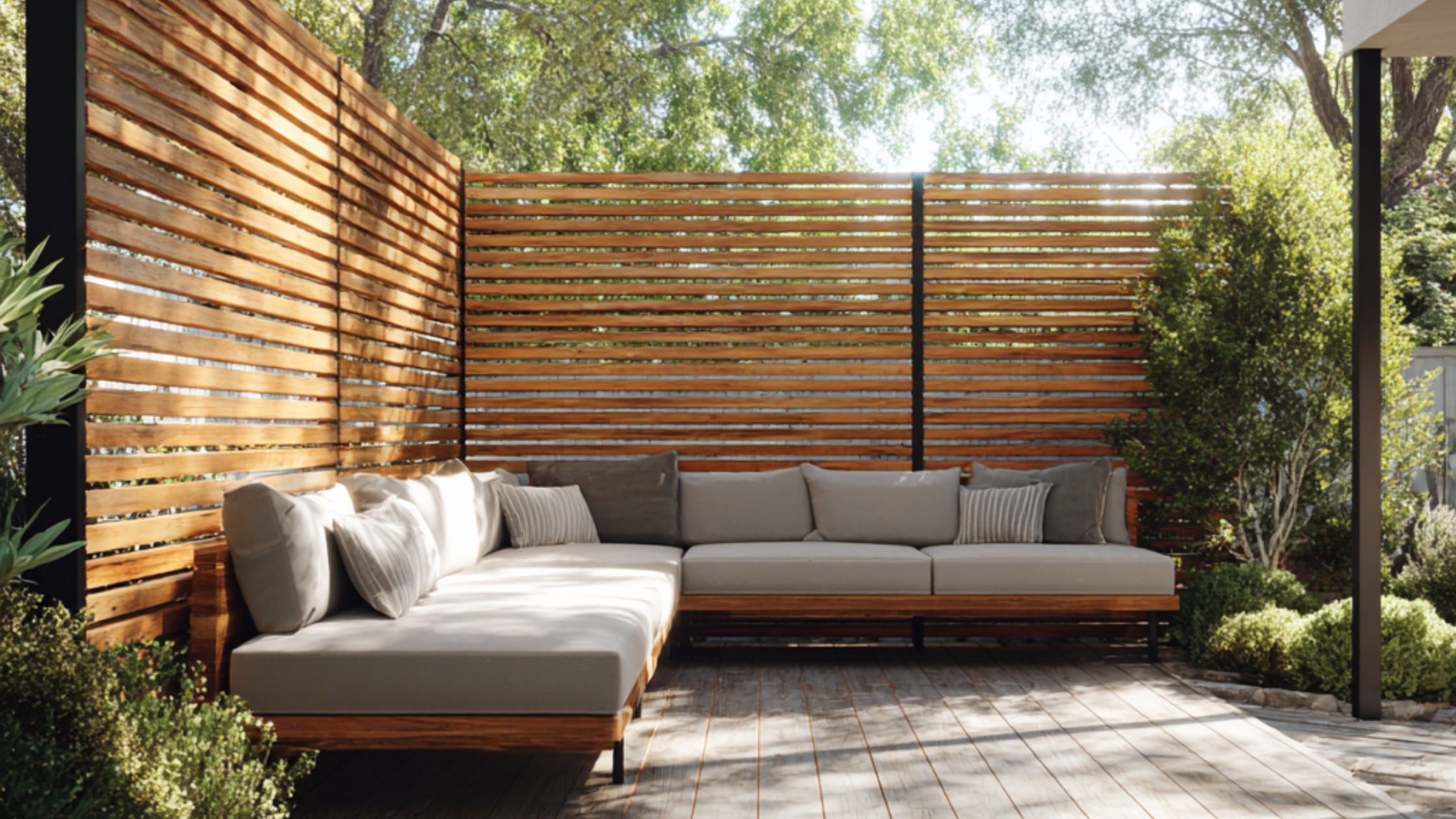A contemporary deck framed by horizontal wood slat screens mounted on black metal posts. Evenly spaced slats create a sleek deck privacy wall that filters light and shields the outdoor living space from neighbors. A durable, weather-resistant example of modern deck privacy wall ideas.
