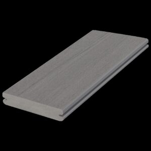 A single grooved deck board from the Fiberon Promenade collection in the Moonlit Cove color. The board features a soft gray tone with subtle woodgrain texture and cool undertones. Its side grooves allow for hidden fastener installation, offering a clean, seamless look ideal for contemporary outdoor spaces.