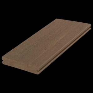 Angled product view of a single Fiberon Promenade Sandy Pier grooved-edge board, highlighting its soft brown color with faint streaks, realistic woodgrain pattern, and grooved edge designed for hidden fasteners.