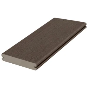 A close-up angled view of the Fiberon Promenade Weathered Cliff grooved deck board. The board features a rich, dark brown surface with subtle grey undertones and a matte texture, highlighting its capped composite construction and clean groove detailing for hidden fasteners.