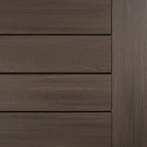 Close-up of TimberTech Landmark Collection decking in American Walnut, showcasing its rich brown tone with elegant undertones and a woodgrain texture that mimics natural hardwood.