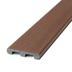 A close-up view of a Deckorators Distressed Cherrywood composite deck board, shown from a slight angle. The board features a solid-edge profile with warm reddish-brown coloring that mimics the natural grain of aged cherry hardwood. The textured low-gloss surface displays realistic woodgrain details, while the gray composite core is visible at the edge, highlighting its durability and low-maintenance benefits. Ideal for borders, picture-frame accents, or custom decking layouts.
