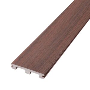 Deckorators Distressed Cherrywood slotted deck board shown in angled close-up. The reddish-brown composite surface includes subtle black undertones and a convincingly realistic woodgrain texture that resembles hand-finished cherry lumber. The groove along the side edge supports hidden fasteners for a sleek, nail-free installation. The board's design blends warmth and authenticity with long-lasting, weather-resistant performance.