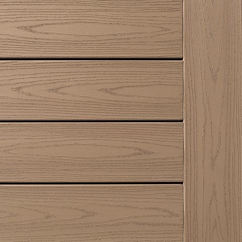 Close-up of TimberTech Harvest Collection deck boards in Brownstone, showcasing a soft, warm tan hue with refined cathedral grain patterns. The smooth matte finish mimics stained wood while offering a clean, timeless look perfect for classic outdoor spaces.