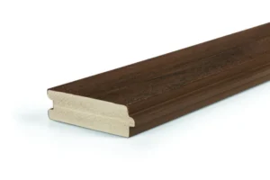 Close-up side view of TimberTech Porch English Walnut tongue-and-groove deck board showcasing its capped PVC surface in a deep brown shade and detailed woodgrain texture.