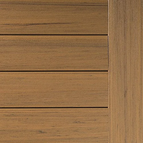 Close-up of TimberTech Prime+ deck boards in Coconut Husk. The boards show a medium brown tone with warm undertones and faint black streaking for a realistic wood look. The horizontal boards are cleanly lined, with a single vertically placed board on the right side showing the same grain. The surface has a straight wood grain texture and matte finish.