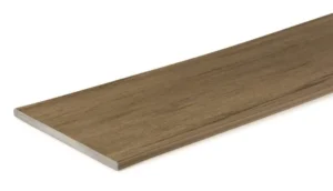 Angled view of the TimberTech Prime+ Coconut Husk composite fascia board, showcasing its warm golden-brown tones and realistic straight wood grain texture. Designed for use along deck perimeters, this board offers a consistent look with the rest of the decking collection.