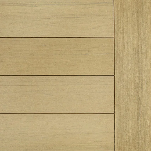 Close-up of TimberTech Terrain+ decking in Natural White Oak, featuring a soft, creamy hue with realistic wood grain detailing. The image displays smooth, horizontally laid boards with a single vertical edge board on the side. The finish offers a light and airy hardwood look ideal for modern outdoor spaces.