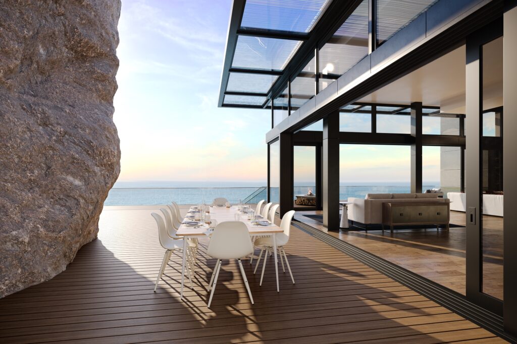Dining terrace on coastal cliff featuring Trex Signature Ocracoke decking.