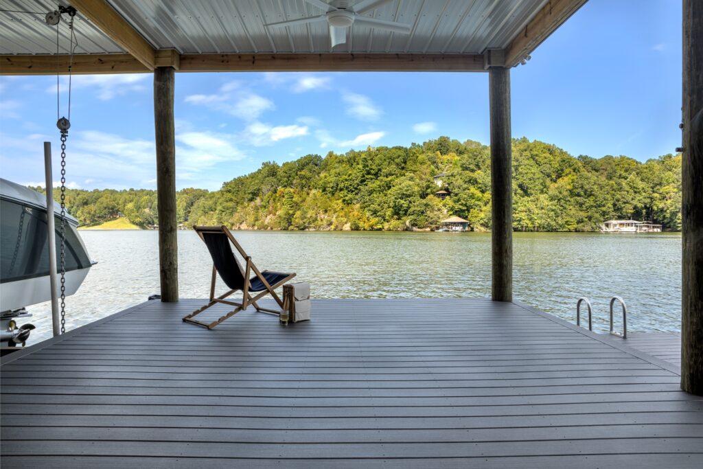 Covered dock with Trex Signature Whidbey decking, overlooking a calm lake and surrounded by lush greenery.