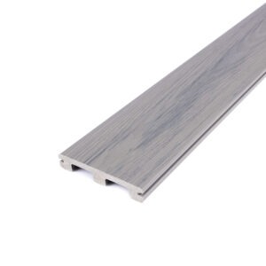 Angled close-up of a Deckorators Altitude grooved-edge board in Trailstone, featuring a light gray surface with cool undertones and realistic wood-grain texture. The scalloped grooved profile reduces weight while maintaining strength and a clean, fastener-free appearance.