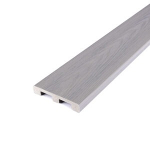 Angled close-up of a Deckorators Altitude solid-edge board in Trailstone, showing its smooth light gray finish and authentic wood-grain pattern. The solid-edge design is ideal for borders or stair treads, providing a seamless look with lasting durability.