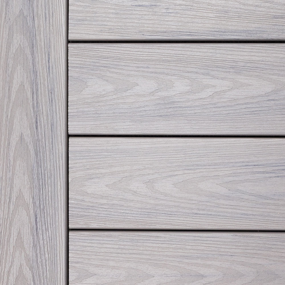 Close-up of Deckorators Altitude Trailstone decking in a soft cool gray tone with refined woodgrain texture.