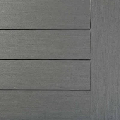 Close-up view of TimberTech Premier Maritime Gray composite decking, featuring a cool, medium gray tone with a smooth matte finish and straight-grain detailing. The surface mimics the look of painted wood with clean, modern lines.