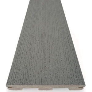 Single grooved-edge board of TimberTech Prime Maritime Gray composite decking shown against a white background. The board has a cool-toned medium gray surface with low-contrast streaking and a fine wood grain texture. Designed for durability and moisture resistance, this capped board features clean, straight edges and a natural finish that mimics brushed wood.