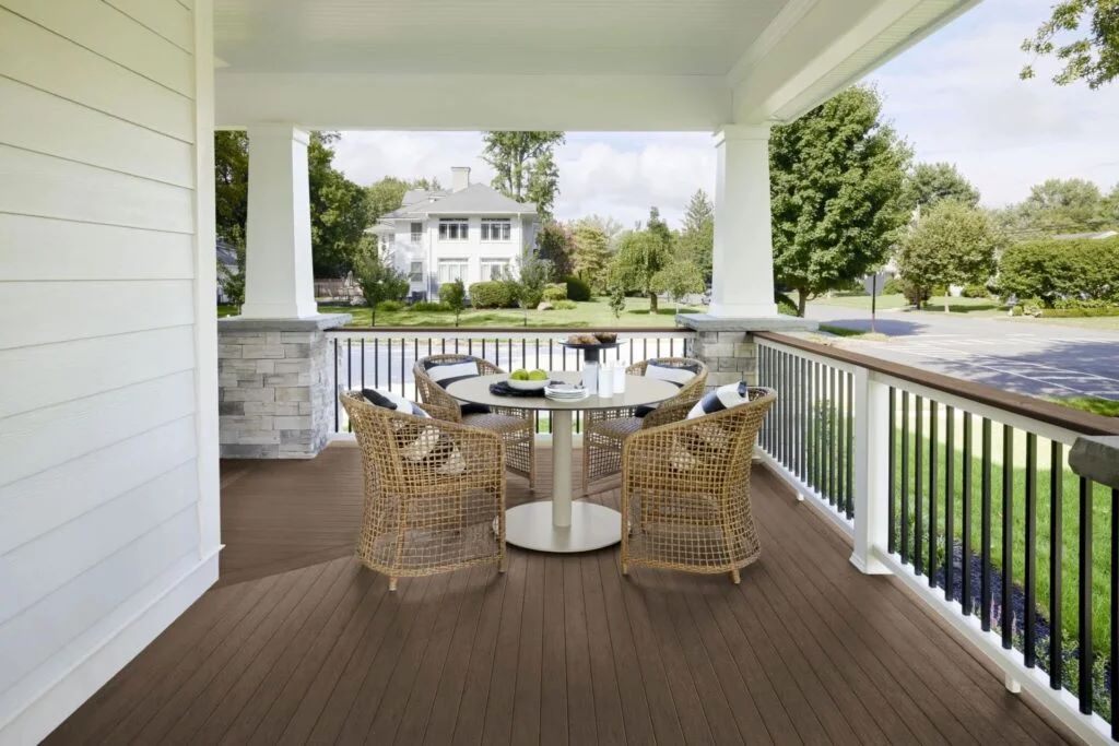 Elegant mid-brown TimberTech Vintage English Walnut decking installed beside a beige stucco house. The natural wood look enhances the home’s warm tones, providing a classic example of deck colors for beige house pairings.