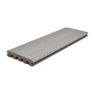 Trex Enhance Pebble Beach grooved-edge composite decking board in soft gray with wood-grain finish, designed for hidden fastener systems and smooth, uniform deck surfaces.