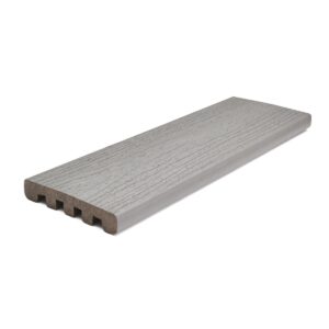 Trex Enhance Pebble Beach square-edge composite decking board in light coastal gray, featuring realistic wood-grain texture and durable scalloped profile for classic installation.