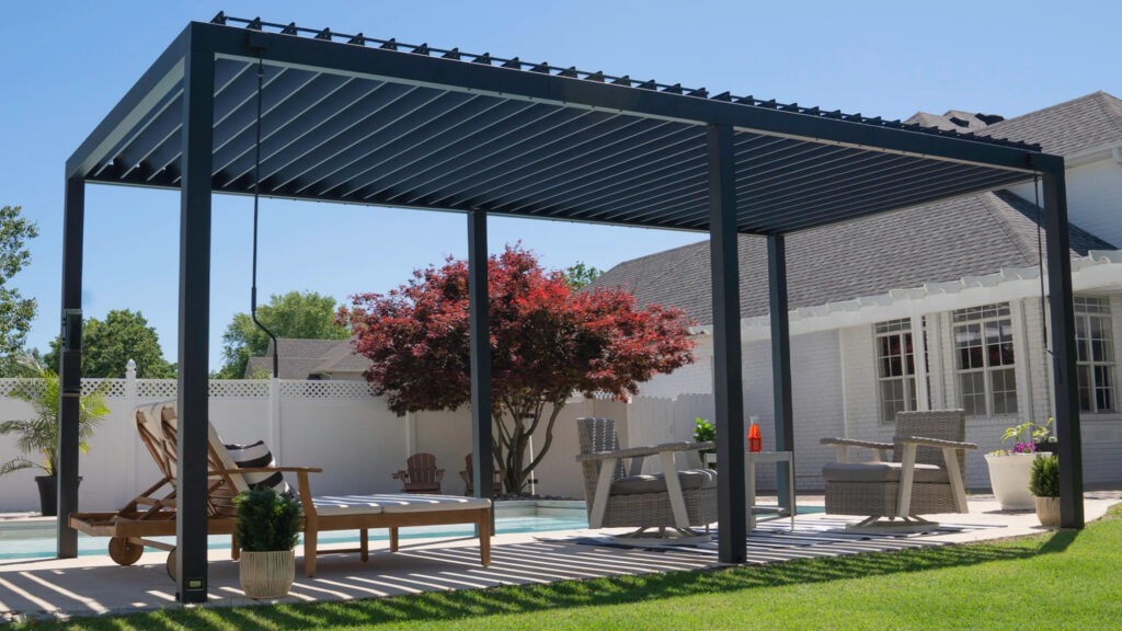 Contemporary black aluminum pergola beside pool with modern outdoor lounge furniture.