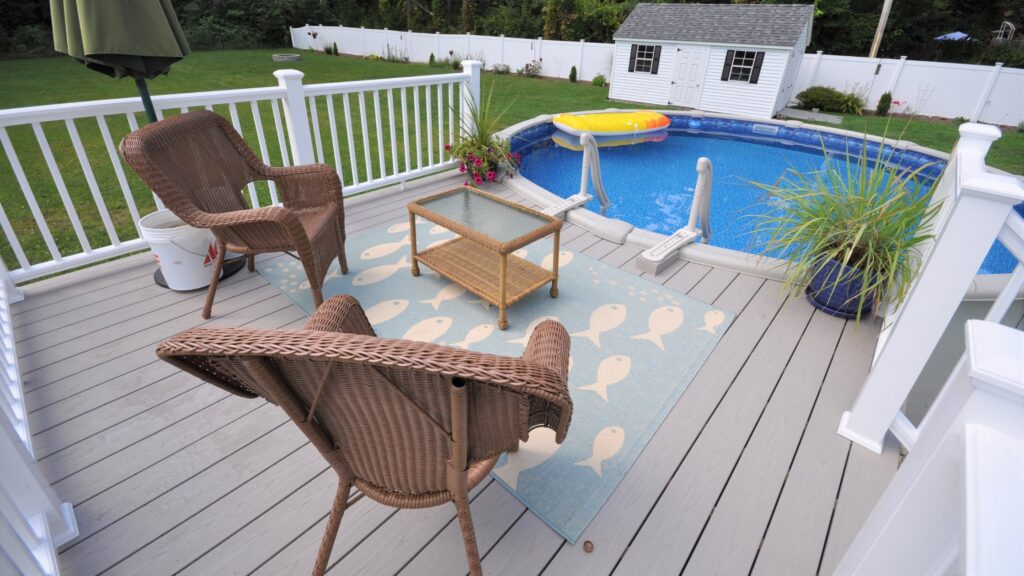 Cozy patio deck with wicker chairs, small round pool, and patterned rug.